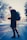 selective focus photography of man in black coat carrying gray backpack
