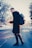 selective focus photography of man in black coat carrying gray backpack