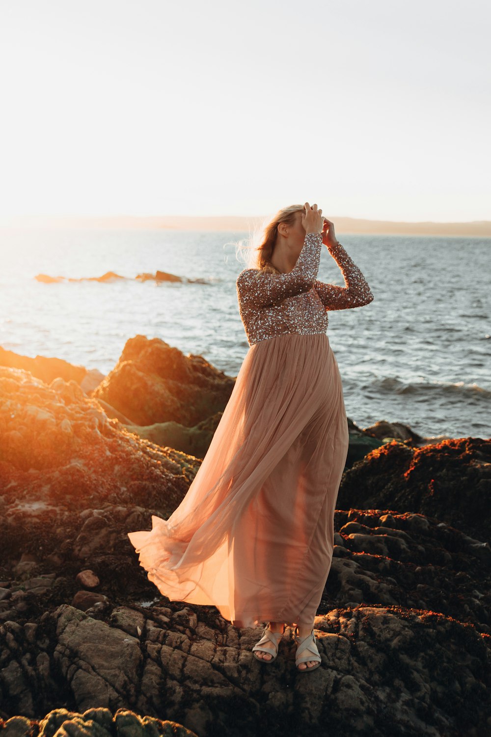 woman standing on rock formation