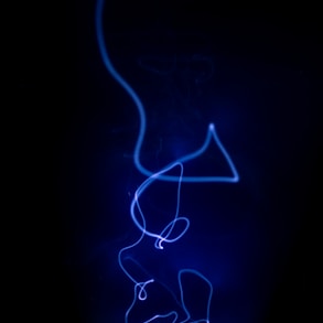 a blue light is shining on a black background