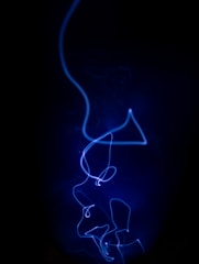A fluid motion abstract shape glowing in neon purple against a deep black background.
