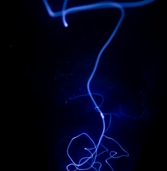 a black background with a blue light in the dark