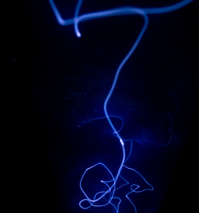 a black background with a blue light in the dark