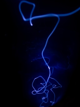 a black background with a blue light in the dark