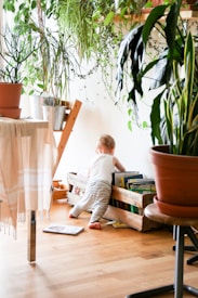 toddler wearing white tank top near white wall