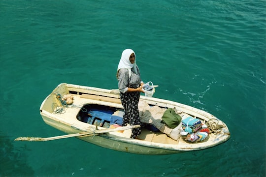 woman standing on middle of boat in Kaş Turkey