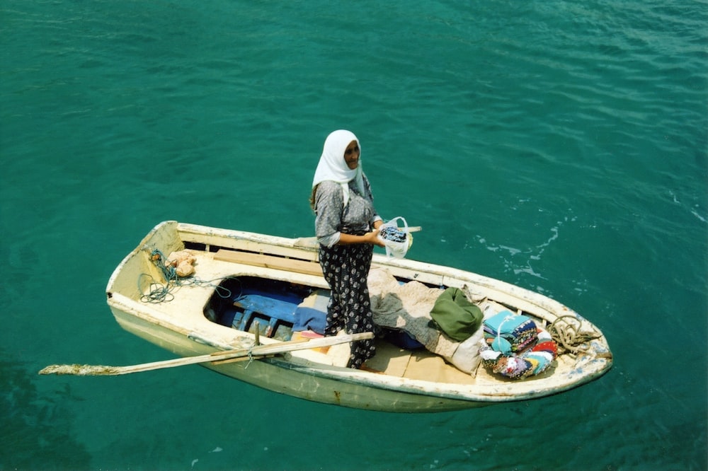 woman standing on middle of boat