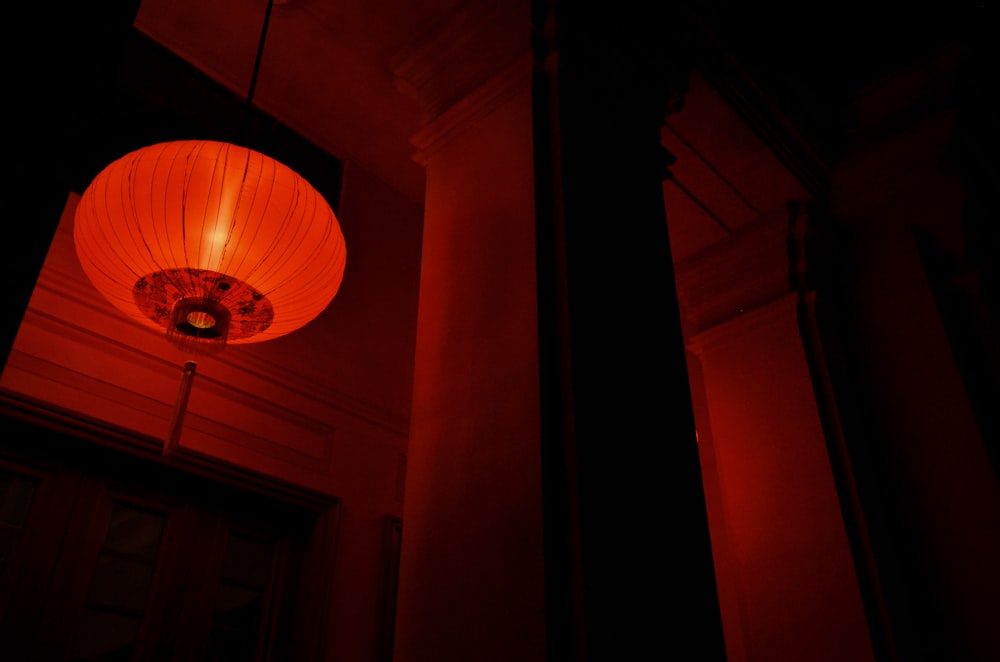 low angle photo of lighted red paper lantern