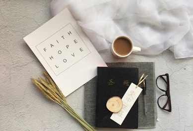 A warm, inviting flat lay of faith-inspired journals and rose gold pens on an ivory background.