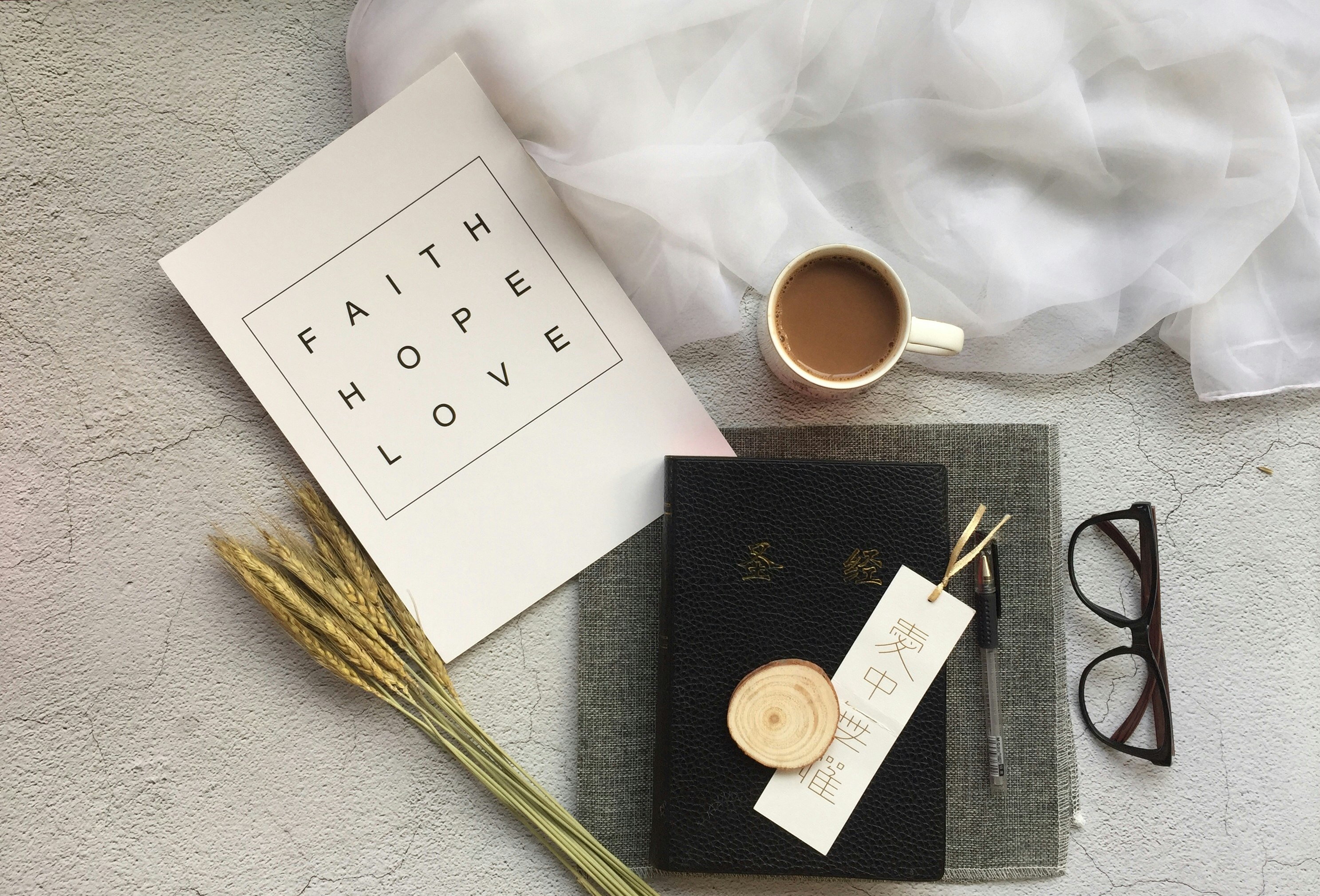 white ceramic mug near black-framed eyeglasses