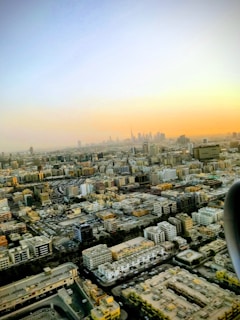 An aerial view of a sprawling Indian city skyline at sunset, symbolizing rapid urban growth.