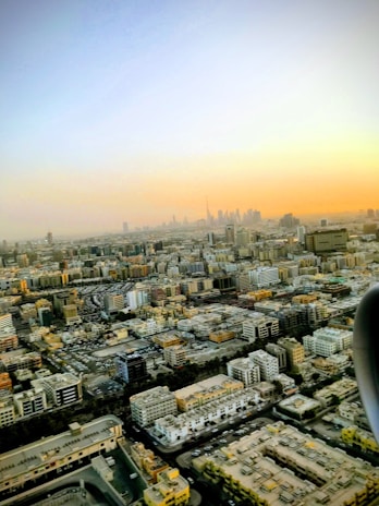 An aerial view of a sprawling Indian city skyline at sunset, symbolizing rapid urban growth.