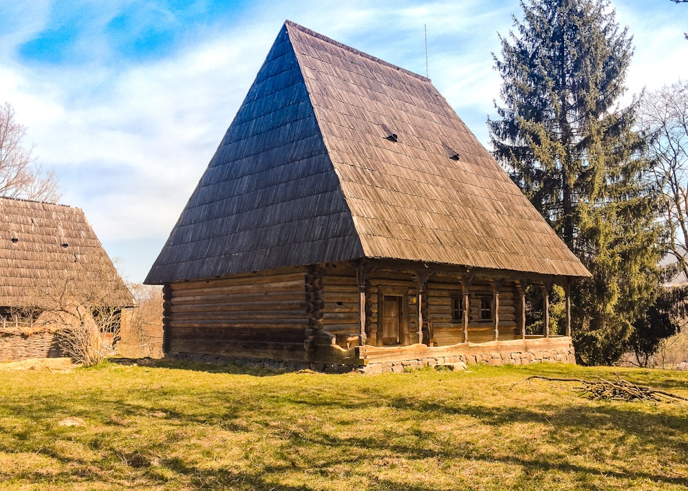 brown wooden house in front of tree