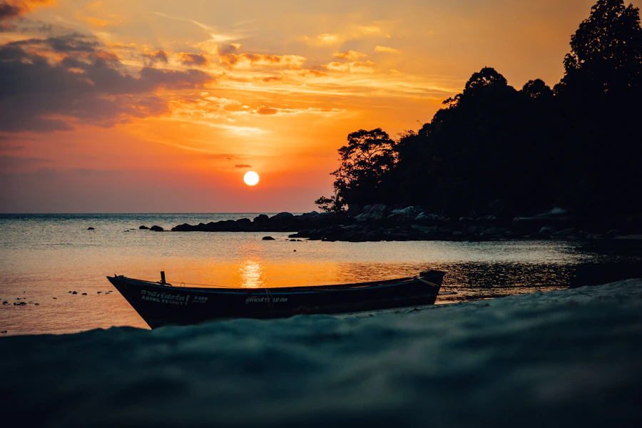 Boat near seashore at sunset