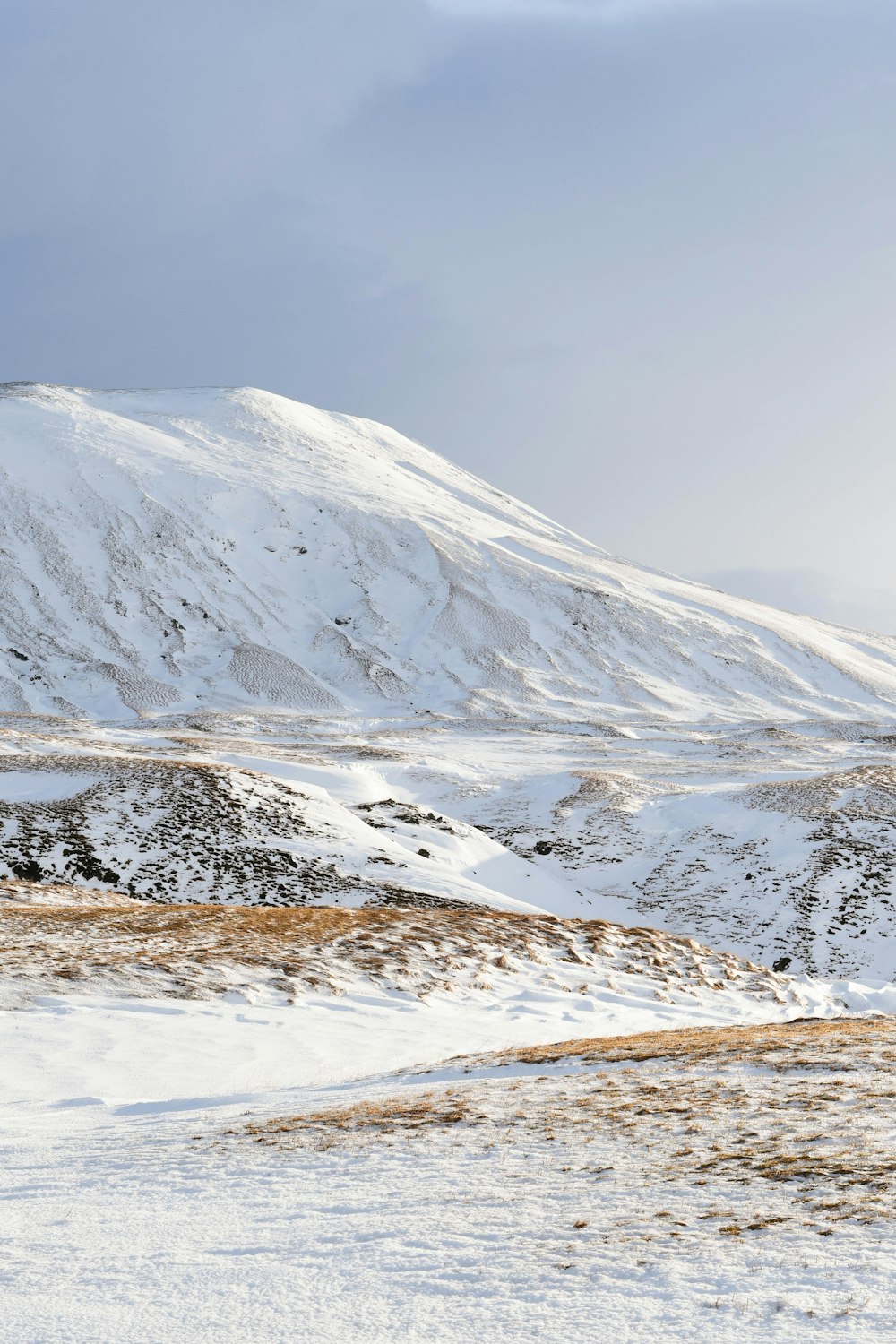 snow capped mountain under cloudy sky