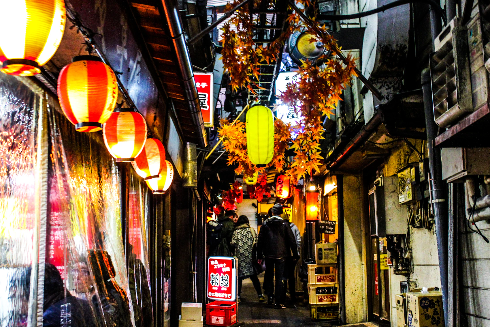 A narrow Shinjuku alley filled with lanterns and small izakaya counters