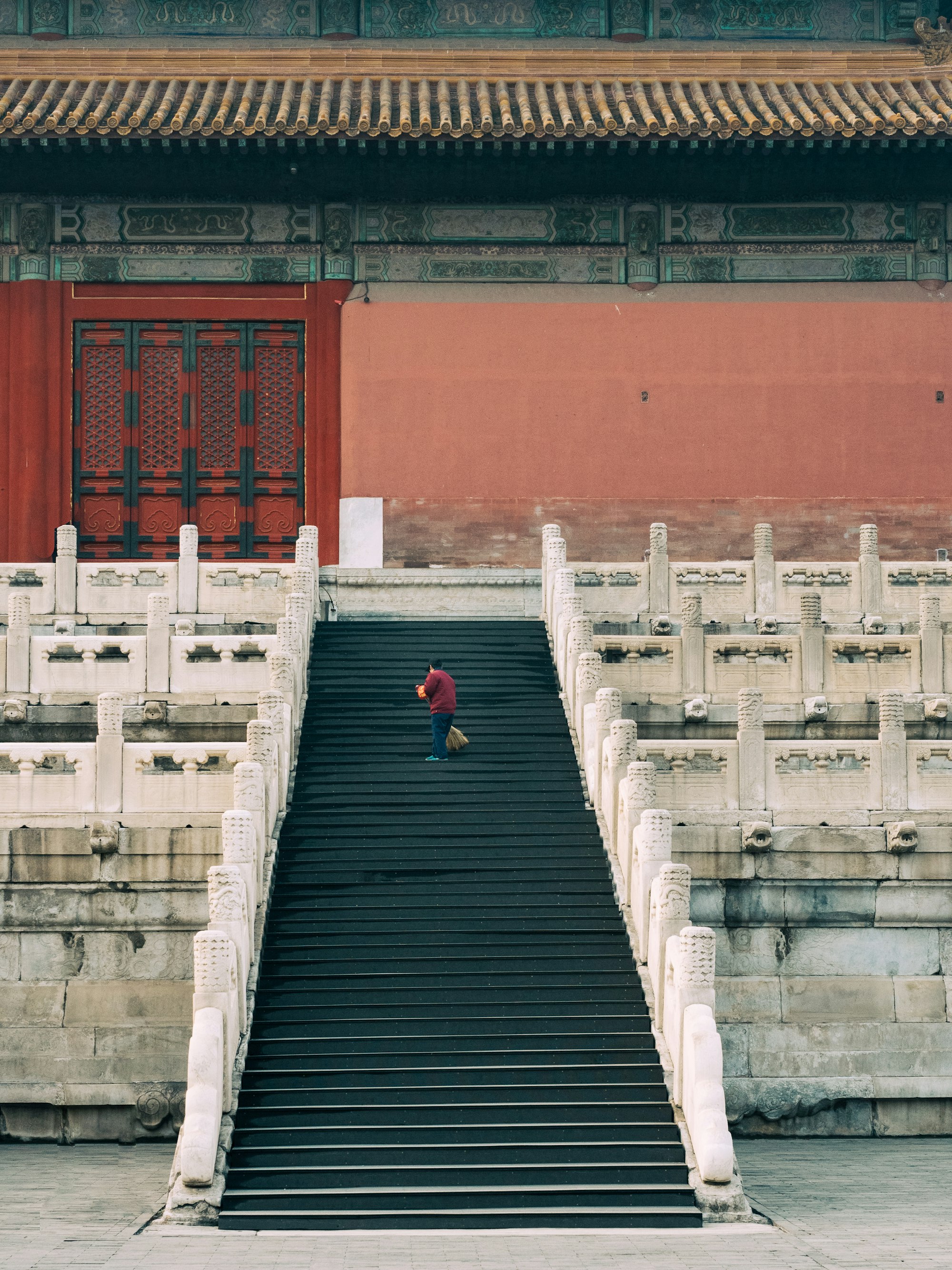 Person standing on steps leading up to Chinese palace - representing the path through the HSK levels.