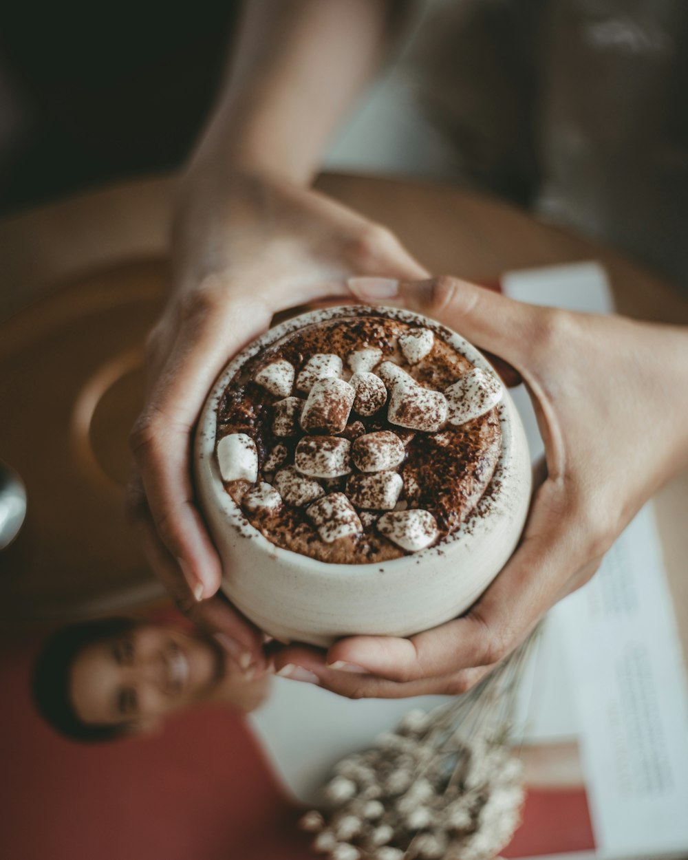 a person holding a bowl of food in their hands