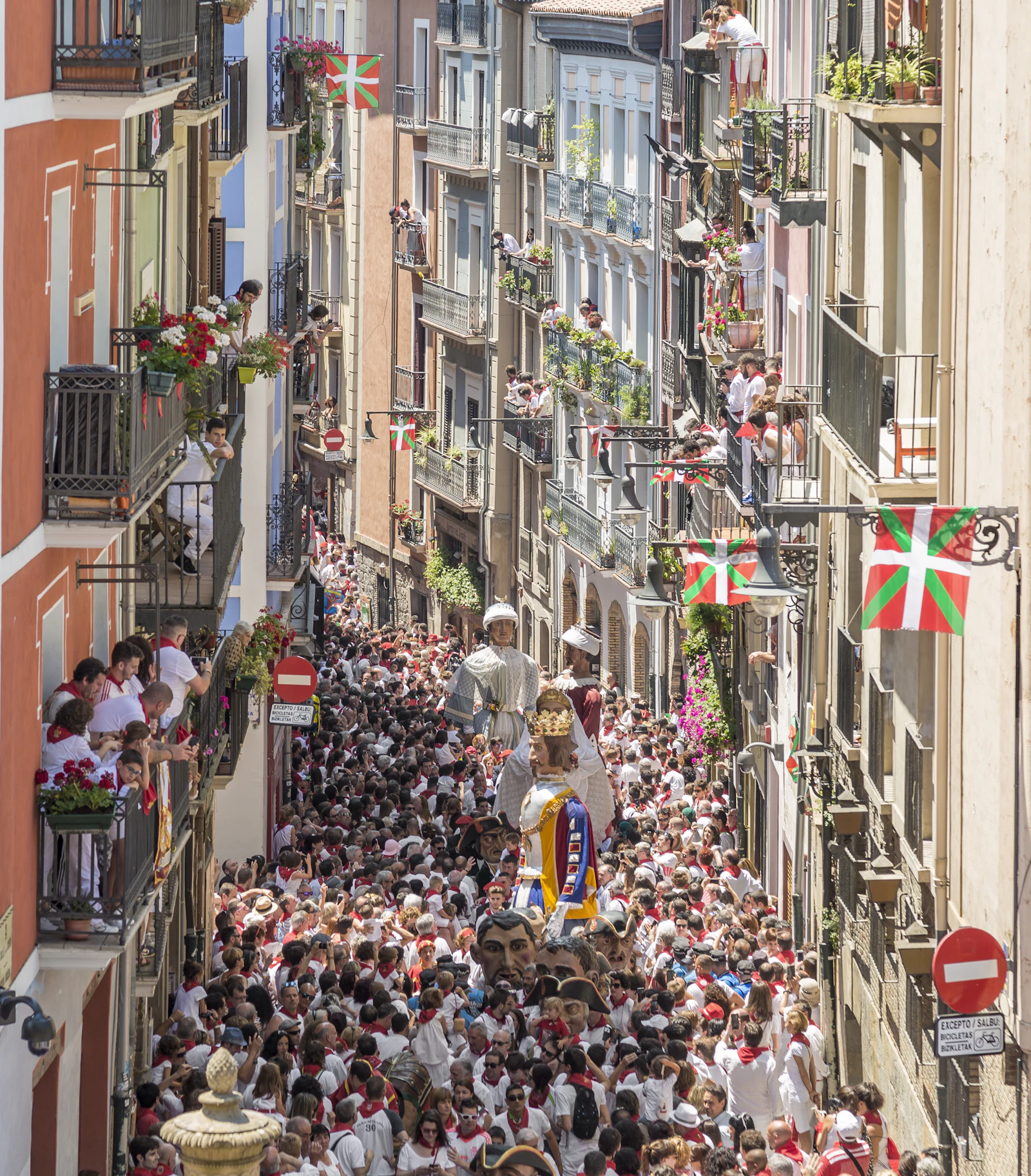 Crowd of San Fermín revelers in white and red on the streets of Pamplona, Spain