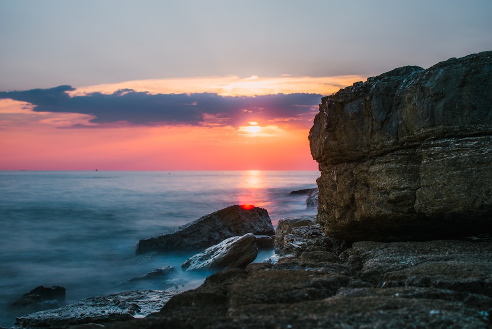 stone formation beside body of water