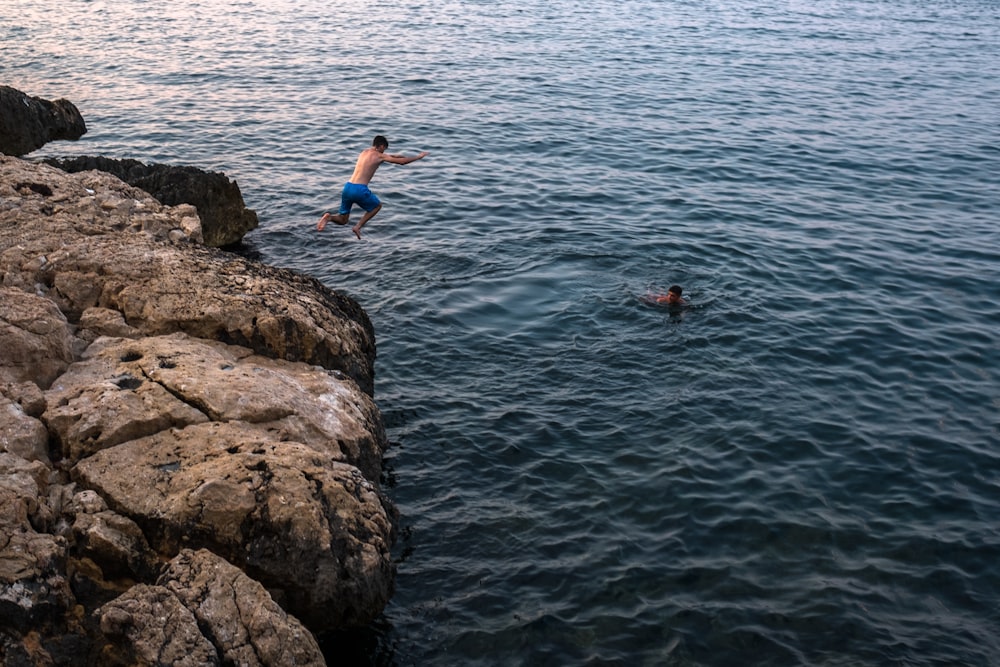 man jumping on cliff