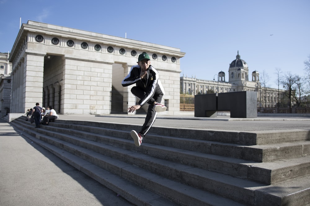 person jumping on concrete stair