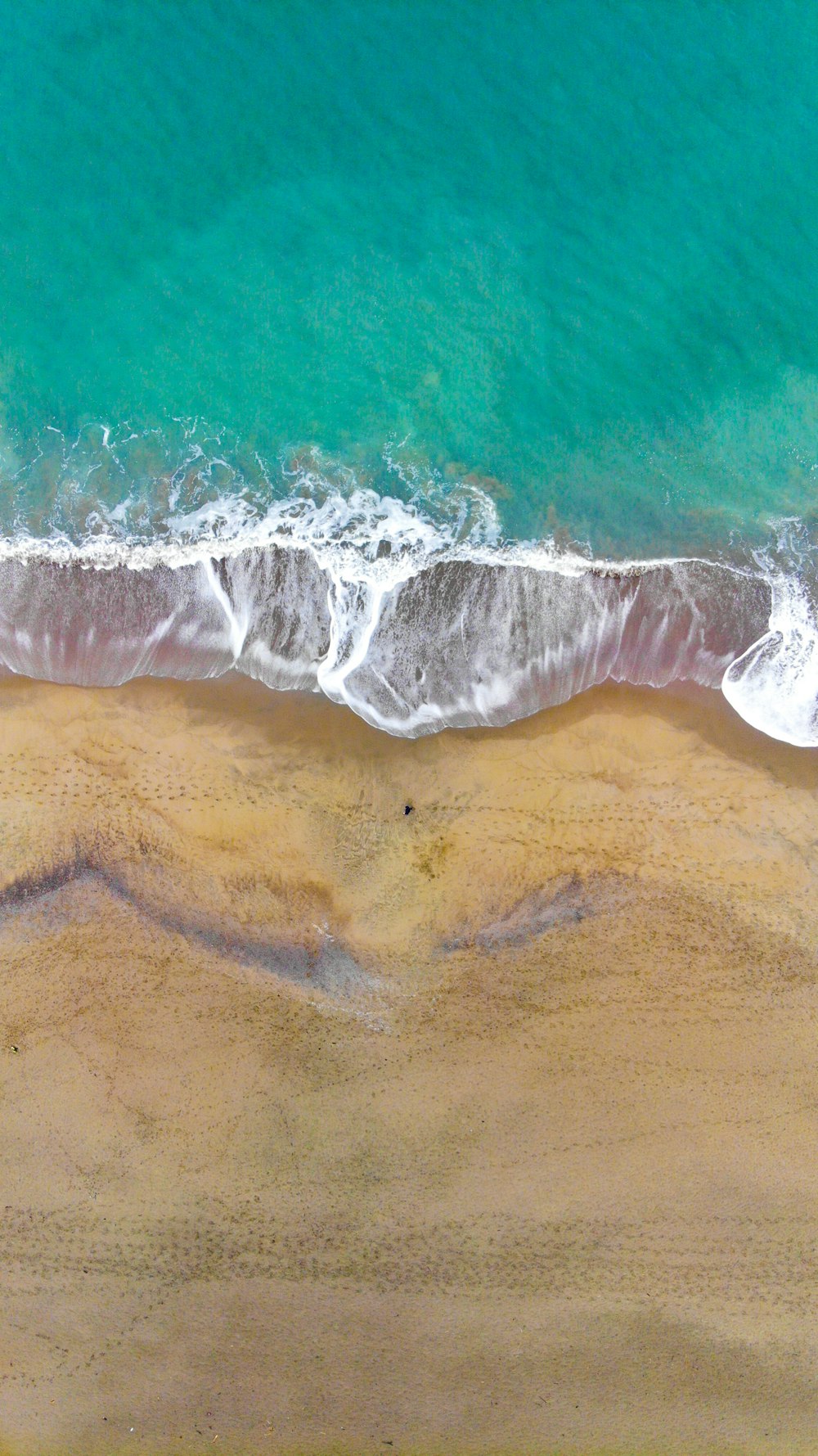 body of water waving on seashore