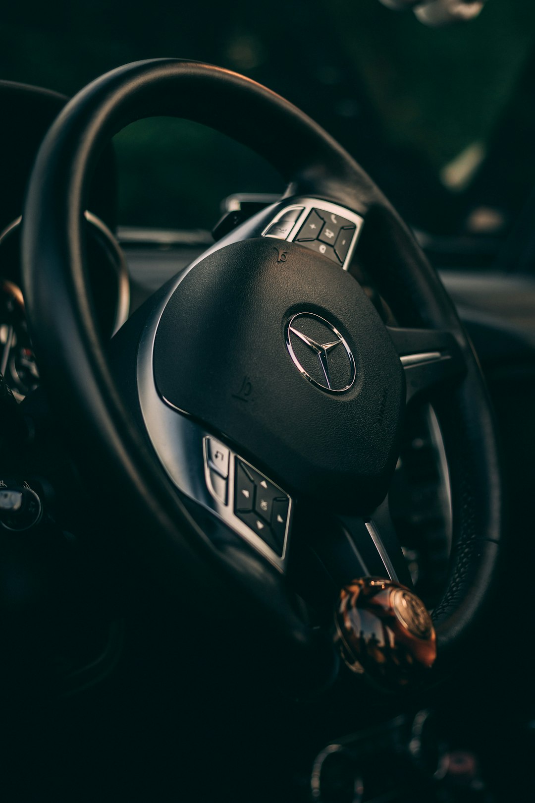 close up photo of Mercedes-Benz steering wheel