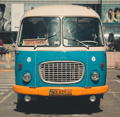 blue classic van parked on parking lot during day