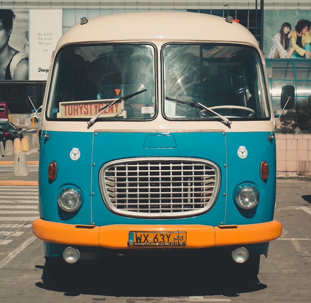 blue classic van parked on parking lot during day