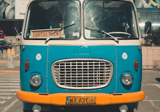 blue classic van parked on parking lot during day