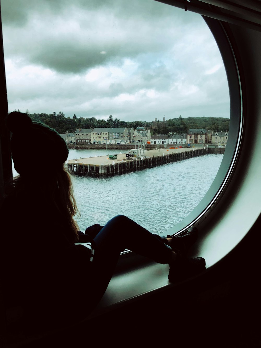 woman sitting on window