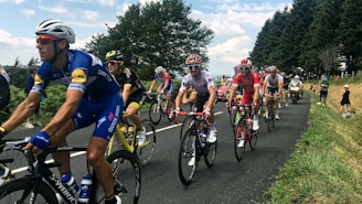 A cyclist racing on a scenic road during a cycling competition.