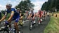 a group of people riding bikes down a road