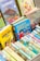 A collection of colorful children's books with illustrated covers, prominently featuring titles by Enid Blyton. The books are neatly arranged in a box, showcasing a variety of themes, including circus, adventure, and fantasy.