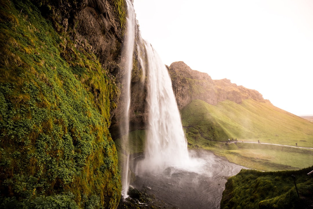 waterfalls raging surrounded by mountain