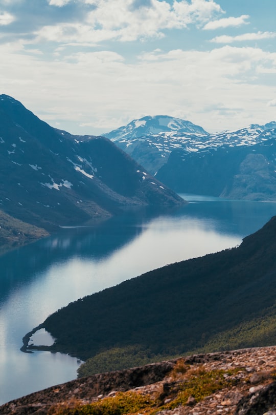 landscape photography of body of water surrounded by mountains in Besseggen Norway