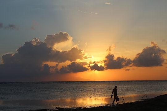 man walking near body of water in Calatagan Philippines