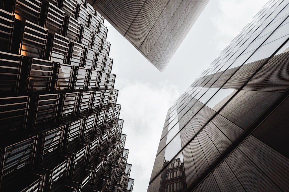 low angle of three gray high rise buildings