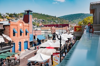 A lively street scene in historic Blountstown with charming old buildings and people enjoying a community festival.