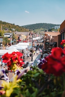 A vibrant street scene in Addis Ababa bustling with locals and colorful market stalls under a bright sky.
