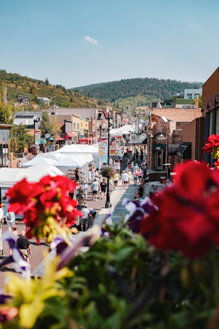 A vibrant street scene in Yorkshire with colorful market stalls and locals chatting.