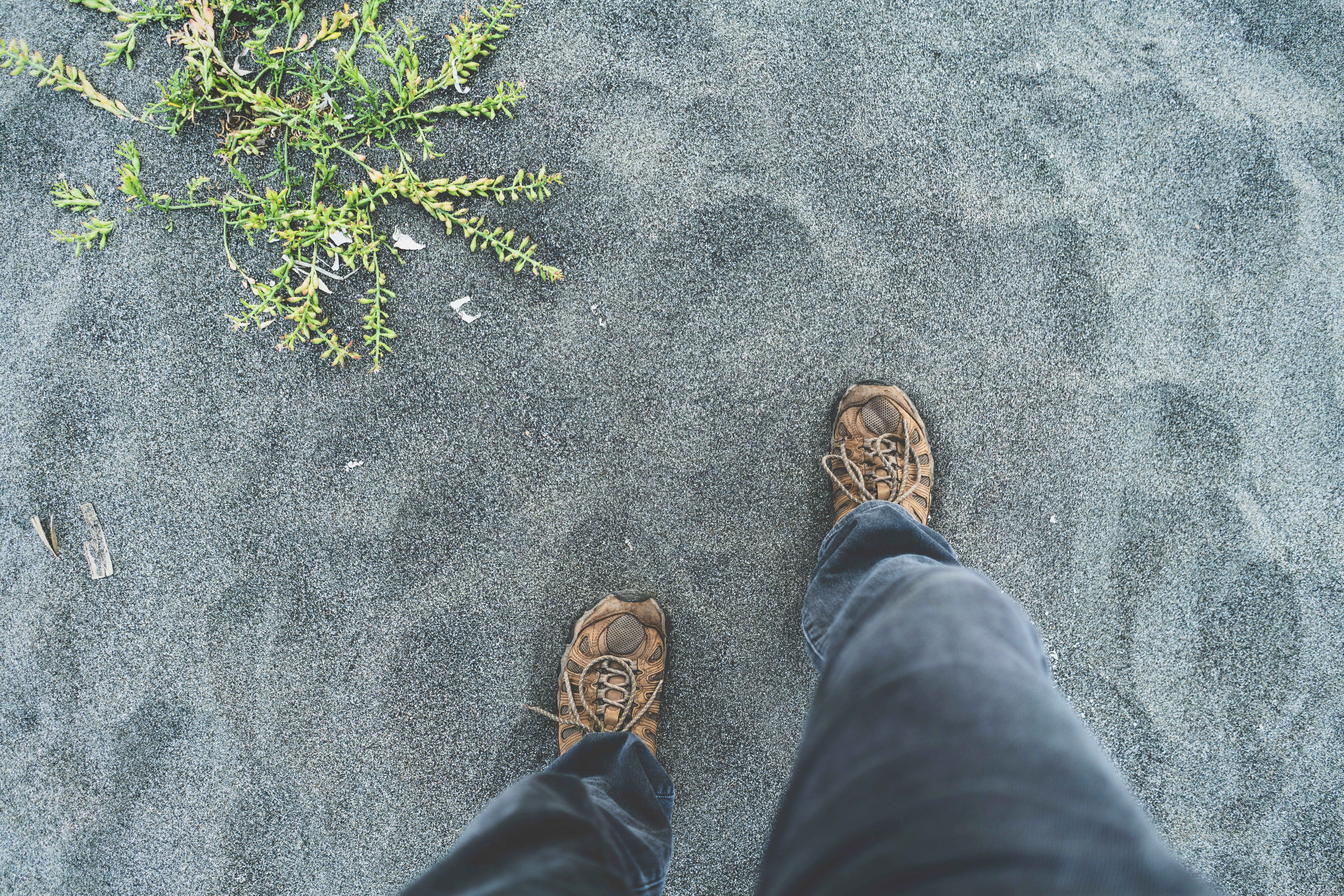 person standing on gray sand