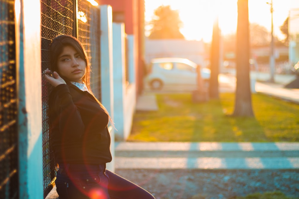 woman leaning on fence