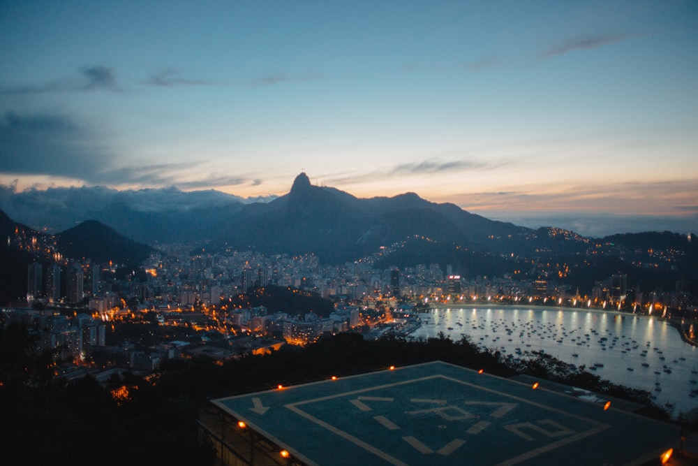 aerial photography of buildings and mountains at blue hour