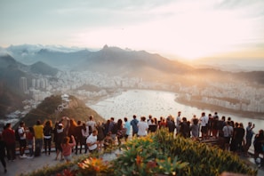 Travelers admiring the skyline of Hong Kong from a high viewpoint at sunset
