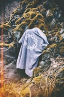 gray cloth on rock with moss