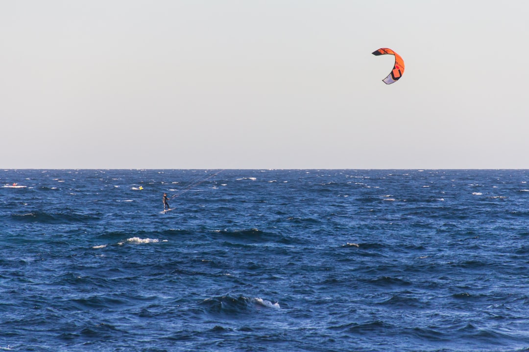 person parasailing on water