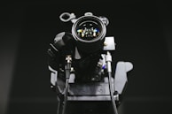 Close-up of a professional video camera lens focusing during a live broadcast.