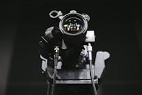 Close-up of a professional camera lens capturing a corporate video shoot.